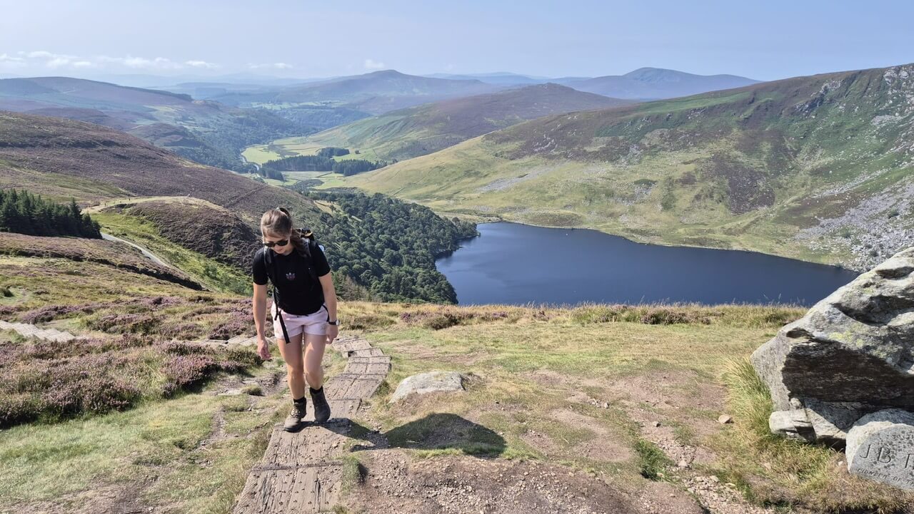 wkw hiker climbing wooden path over lough tay