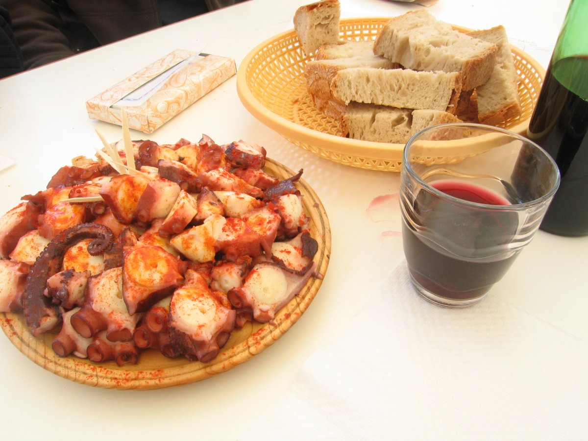 Polbo á Feira / Pulpo a la Gallega, a traditional Galican dish, served with bread and wine 