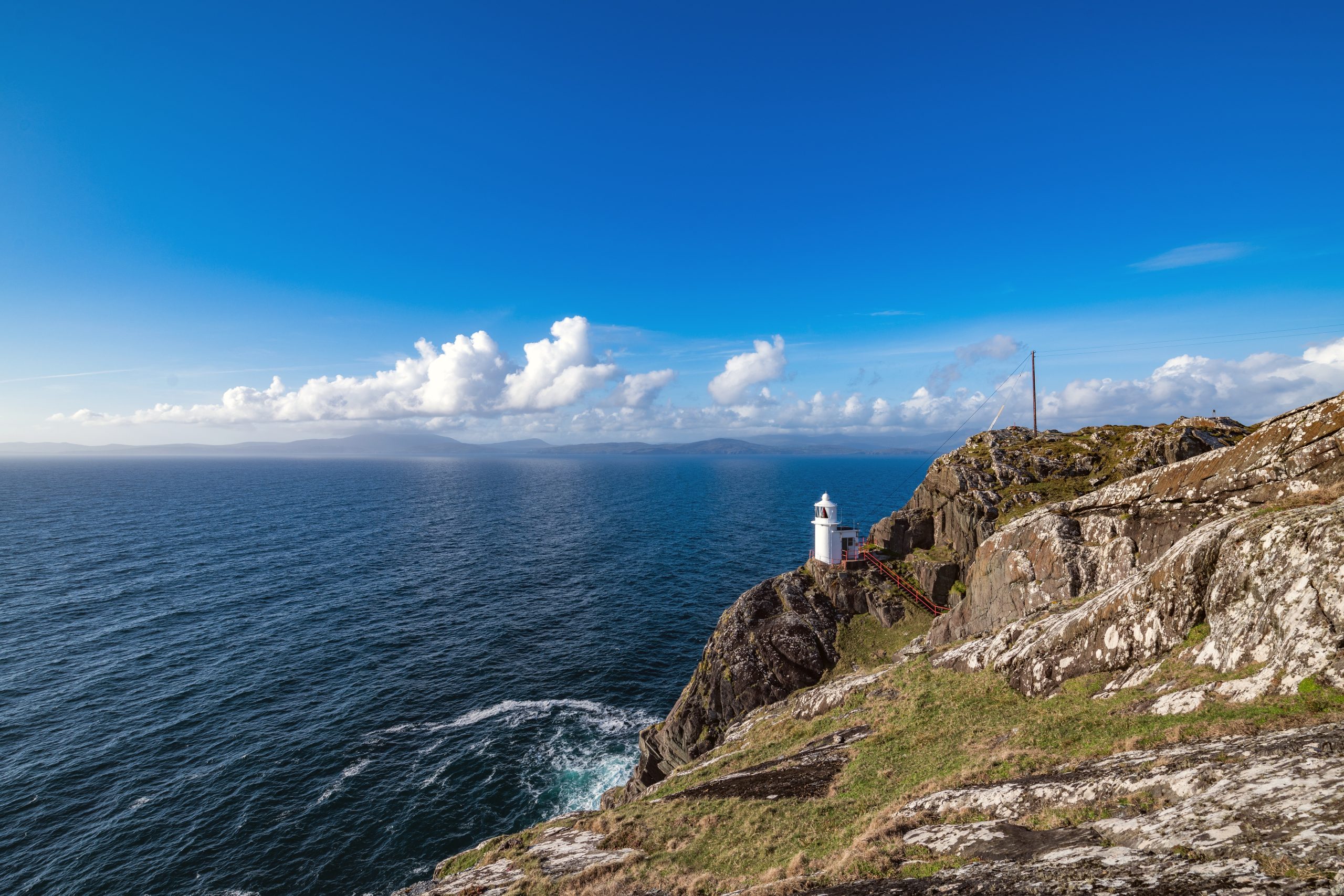 sheep's head lighthouse at the end of sheep's head peninsula in ireland