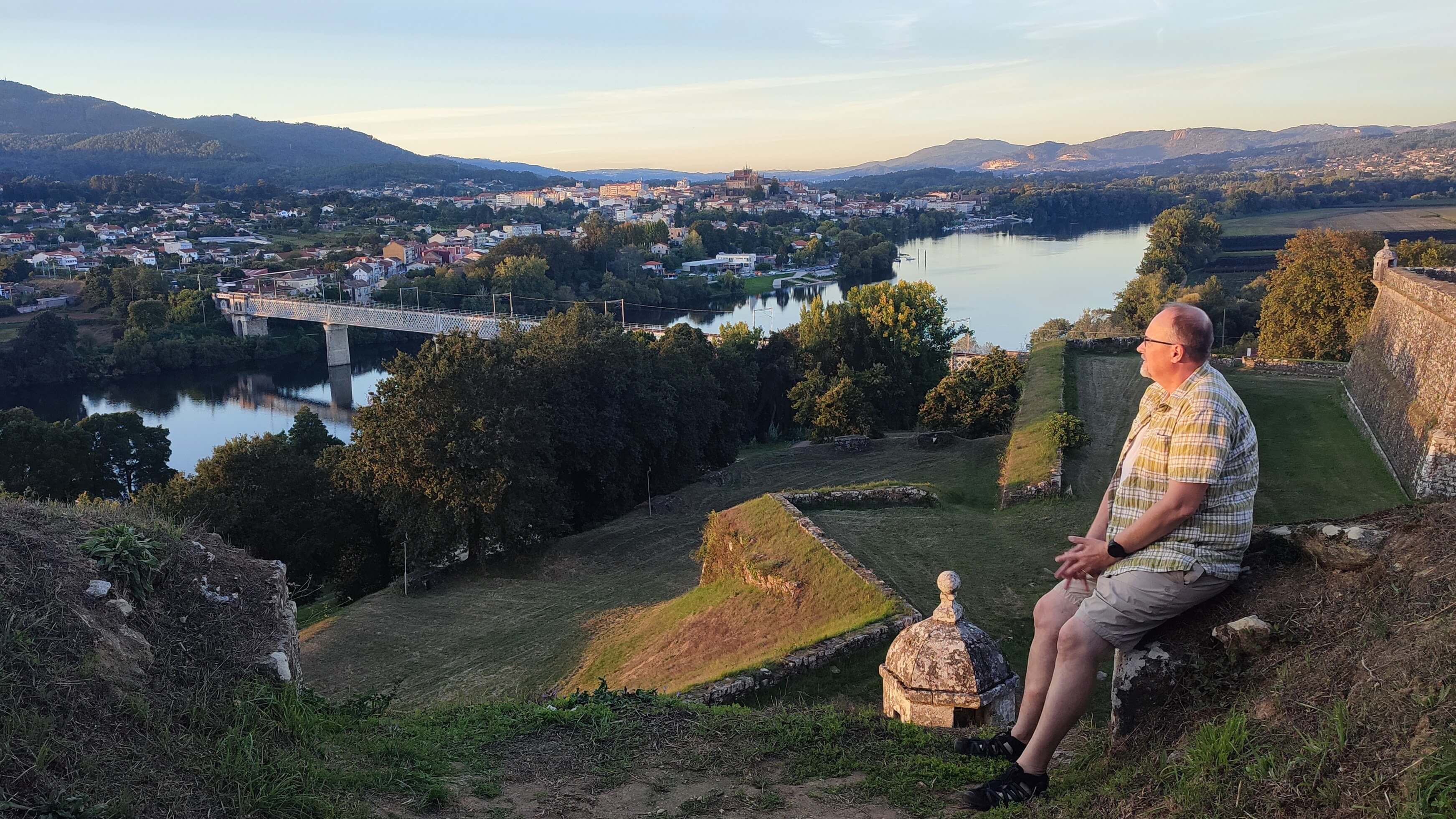 View of Valença Fortress, Minho River and Tui with sitting walker